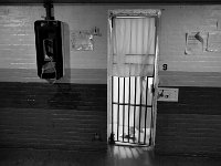 An inmate walks into the shower cell in the area reserved for inmates serving time.  The towels put up by inmates to attempt at some privace.  The telephone to the left can be used by any inmate but is accessed using a PIN number that needs to be set up by a family member with preparid plan.   The Bristol County Jail and House of Correction on Ash St. in New Bedford, MA was built in 1829 and is the oldest operating jail in the country.  Almost all of the inmates at the jail are awaiting trial date.  Eighteen of the inmates have been sentenced and are active in the maintenance of the facility.