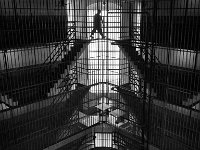 An inmate walks back to his cell after being out in the courtyard.  The Bristol County Jail and House of Correction on Ash St. in New Bedford, MA was built in 1829 and is the oldest operating jail in the country.  Almost all of the inmates at the jail are awaiting trial date.  Eighteen of the inmates have been sentenced and are active in the maintenance of the facility.