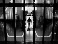 An inmate walks back into the cell block after having lunch.  The Bristol County Jail and House of Correction on Ash St. in New Bedford, MA was built in 1829 and is the oldest operating jail in the country.  Almost all of the inmates at the jail are awaiting trial date.  Eighteen of the inmates have been sentenced and are active in the maintenance of the facility.