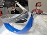 Nurses in the CCU at St. Luke's Hospital in New Bedford, where many of the COVID-19 patients are being treated, speak with each other at one of the nurse stations.  PHOTO PETER PEREIRA