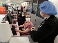 Nurses in the CCU at St. Luke's Hospital in New Bedford, where many of the COVID-19 patients are being treated, speak with each other at one of the nurse stations.  PHOTO PETER PEREIRA