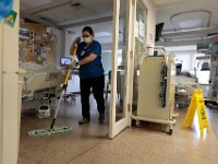 Vera DaPonte, of housekeeping, cleans the floors of one of the rooms in the ICU at St. Luke's Hospital in New Bedford.  PHOTO PETER PEREIRA