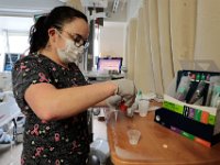 Nurse, Jenna Soares, prepares medication for a patient in ICU at St. Luke's Hospital in New Bedford.  PHOTO PETER PEREIRA]