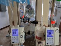 Dr. Michael Barretti, checks in on a COVID-19 patient in critical condition inside one of the sealed rooms of the St. Luke's Hospital ICU in New Bedford, MA. PHOTO PETER PEREIRA