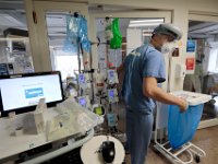 Dr. Michael Barretti, exits a sealed room containing a COVID-19 patient in critical in the ICU St. Luke's Hospital in New Bedford, MA.  PHOTO PETER PEREIRA