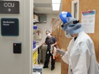 A nurse checks in with Jenna Soares seen inside the room containing IV supplies in the ICU at St. Luke's Hospital in New Bedford.  PHOTO PETER PEREIRA