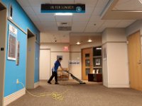 Sukanya Lobo vaccums the area in front of the main elevators at St. Luke's Hospital in New Bedford.  The housekeeping staff has been asked to up their efforts to keep things clean. PHOTO PETER PEREIRA