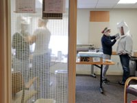 Injury prevention specialist, Beth Lemieux, performs an N95 mask fitting test to RN Natasha Chen at St. Luke's Hospital in New Bedford. The fitting test is performed with any front line worker dealing with COVID-19 patients.  PHOTO PETER PEREIRA