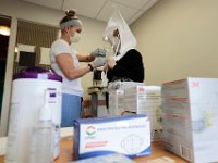 Injury prevention specialist, Stephanie Hart, performs an N95 mask fitting test to RN Kelly Burke at St. Luke's Hospital in New Bedford. The fitting test is performed with any front line worker dealing with COVID-19 patients.  PHOTO PETER PEREIRA