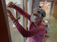 Injury prevention specialist team leader, Kathy Thornton, checks who is scheduled to be fitted with an N95 mask at St. Luke's Hospital in New Bedford. The fitting test is performed with any front line worker dealing with COVID-19 patients.  PHOTO PETER PEREIRA