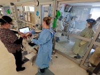 Respiratory therapists, Deborah Sironen and Jennifer Candido, prepare the respirator for a COVID-19 patient in the Knowle's Wing at St. Luke's Hospital in New Bedford.  PHOTO PETER PEREIRA