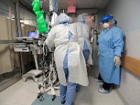 Nurses move a COVID-19 patient into the operating room at St. Luke's Hospital in New Bedford.  PHOTO PETER PEREIRA