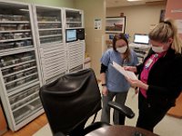 The automated medication dispensing machine is seen in the background, as nurses go over a patients information in the Knowles Wing and at St. Luke's Hospital in New Bedford.  PHOTO PETER PEREIRA