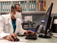 Dr. Dilip Sthapit, checks a patients profile in the Wilkes Wing of St. Luke's Hospital in New Bedford.  PHOTO PETER PEREIRA