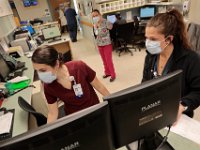 The Wilkes Wing nurse station is filled with activity as nurses check in across a variety of patients including some diagnosed with COVID-19 at St. Luke's Hospital in New Bedford.  PHOTO PETER PEREIRA