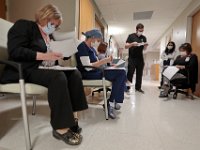 Wilkes Wing nurses and physicians meet in the hallway to discuss their patients and how to proceed for the rest of the day at St. Luke's Hospital in New Bedford.  PHOTO PETER PEREIRA