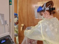 Nurses work to remove items from a room containing a COVID-19 patient at St. Luke's Hospital in New Bedford.  PHOTO PETER PEREIRA