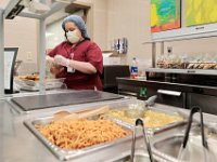 Katelyn Jean prepares cookie bags in the cafeteria at St. Luke's Hospital in New Bedford.  PHOTO PETER PEREIRA]