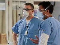 Dr. Michael Barretti and Dr. Vikram Doraiswamy confer with each other regarding a COVID-19 in critical condition at St. Luke's Hospital in New Bedford.  PHOTO PETER PEREIRA