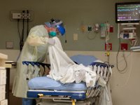Jim Kaiser, RN, checks on a patient inside the ER at St. Luke's Hospital in New Bedford.  PHOTO PETER PEREIRA