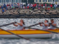 People watch from the shoreline as the XII International Azorean Whaleboat Regatta rowing takes place in Clarke's Cove in New Bedford after a six year hiatus.