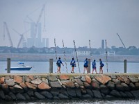 Women from the Azorean island of Faial walk toward their boat docked at the Community Boating Center, before rowing in the XII International Azorean Whaleboat Regatta which took place in Clarke's Cove in New Bedford after a six year hiatus.