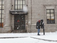 A man uses a payphone in downtown New Bedford  as a snow storm sweeps across the area.  [ PETER PEREIRA/THE STANDARD-TIMES/SCMG ]