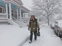 Ethan Lord braves the snow to make his way to his sick girlfriends house with some soup he made for her as a snow storm sweeps across the area.  [ PETER PEREIRA/THE STANDARD-TIMES/SCMG ]