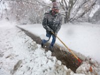 Ernie (no last name) clears the sidewalk around his home on Rockdale Avenue in New Bedford as heavy snowfall blankets the region.  [ PETER PEREIRA/THE STANDARD-TIMES/SCMG ]