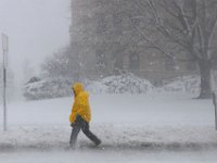 A man walks up Pleasant Street in downtown New Bedford as a snow storm sweeps across the area.  [ PETER PEREIRA/THE STANDARD-TIMES/SCMG ]