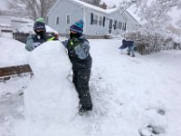 Ryan Trommenschlager, 10 and his cousin Joshua Trommenschlager work on the snowman body as Ryan's dad Timothy Trommenschlager rolls the head in front of their home in New Bedford as heavy snow fall across the region.  [ PETER PEREIRA/THE STANDARD-TIMES/SCMG ]