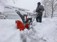 Bob Amaral gives his neighbor a hand in clearing the snow form his driveway in New Bedford. .  [ PETER PEREIRA/THE STANDARD-TIMES/SCMG ]