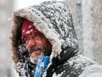 A man braves the snow as he walks up Purchase Street in New Bedford as a snow storm sweeps across the area.  [ PETER PEREIRA/THE STANDARD-TIMES/SCMG ]