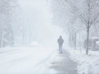 A man makes his way up Union Street as a snow storm sweeps across the area.  [ PETER PEREIRA/THE STANDARD-TIMES/SCMG ]