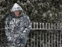 A man makes his way up Union Street as a snow storm sweeps across the area.  [ PETER PEREIRA/THE STANDARD-TIMES/SCMG ]