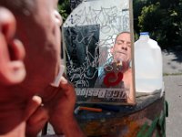 ma nb HomelessinTheWoods  James Soares, 50, shaves near where he lives in the woods behind Save-A-Lot in the north end of New Bedford.  PETER PEREIRA/THE STANDARD-TIMES : poverty, homeless, woods
