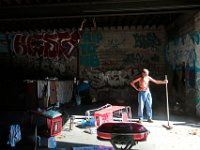 ma nb HomelessinTheWoods  "Papa Doc" takes a break from sweeping the area where he lives in inside a stone structure in the woods behind Save-A-Lot in the north end of New Bedford.   He lives in the cardboard boxes seen on the left.  PETER PEREIRA/THE STANDARD-TIMES : poverty, homeless, woods