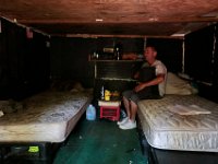 ma nb HomelessinTheWoods  James Soares, 50, folds a pair of pants inside the room he has made from crates in the woods behind Save Rite in the north end of New Bedford.  PETER PEREIRA/THE STANDARD-TIMES : poverty, homeless, woods