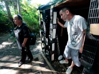 ma nb HomelessinTheWoods  James Soares, 50, steps out from the house he created using crates as Maria Keplar, 43, who also lives in the woods behind Save-A-Lot in the north end of New Bedford walks by.  PETER PEREIRA/THE STANDARD-TIMES : poverty, homeless, woods