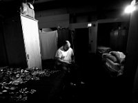 Alan Guilmette puts on a pair of socks after waking up at the House of Hope in New Bedford.  The House of Hope houses over 50 homeless people and has self  quarantined for over three weeks due to the coronavirus pandemic.  No one is allowed in or out of the shelter.  PHOTO PETER PEREIRA