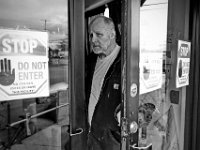 Bob Hughes, locks the front door of the House of Hope. The House of Hope houses over 50 homeless people and has self  quarantined for over three weeks due to the coronavirus pandemic.  No one is allowed in or out of the shelter.  PHOTO PETER PEREIRA