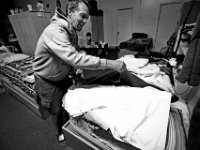 Todd Blackler makes his bed after waking up at the House of Hope in New Bedford. The House of Hope houses over 50 homeless people and has self  quarantined for over three weeks due to the coronavirus pandemic.  No one is allowed in or out of the shelter.  PHOTO PETER PEREIRA