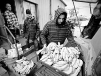 Residents of the House of Hope in New Bedford, form a chain to unload the just arrived food donations sent by the Broken Chains Biker Church in Taunton. The House of Hope houses over 50 homeless people and has self  quarantined for over three weeks due to the coronavirus pandemic.  No one is allowed in or out of the shelter.  PHOTO PETER PEREIRA