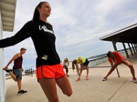 New Bedford lifeguards monitoring the south end beaches go through their morning ritual of stretching, running, swimming and putting out the signs, before monitoring the beaches, as swimming season officially begins.   [ PETER PEREIRA/THE STANDARD-TIMES/SCMG ]