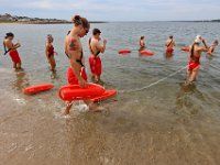 New Bedford lifeguards monitoring the south end beaches go through their morning ritual of stretching, running, swimming and putting out the signs, before monitoring the beaches, as swimming season officially begins.   [ PETER PEREIRA/THE STANDARD-TIMES/SCMG ]
