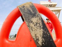 New Bedford lifeguards monitoring the south end beaches go through their morning ritual of stretching, running, swimming and putting out the signs, before monitoring the beaches, as swimming season officially begins.   [ PETER PEREIRA/THE STANDARD-TIMES/SCMG ]