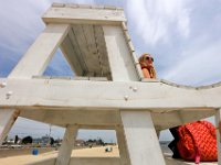 New Bedford lifeguards monitoring the south end beaches go through their morning ritual of stretching, running, swimming and putting out the signs, before monitoring the beaches, as swimming season officially begins.   [ PETER PEREIRA/THE STANDARD-TIMES/SCMG ]