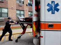 New Bedford EMT, Jason Kirby, wheels an overdose patient into the ambulance before bringing him to the hospital. Paramedic David Branco and Jason Kirby resuscitate an overdose patient in downtown New Bedford. Despite over 12,000 COVID-19 related calls since March, only one part-time EMT has tested positive for the virus.  PHOTO PETER PEREIRA