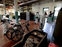 New Bedford firefighters wearing hazmat suits disinfect New Bedford EMS headquarters on Hillman Street in New Bedford.  This is a weekly activity which has helped contain COVID-19 from spreading within the department. PHOTO PETER PEREIRA