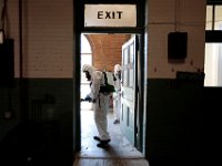 New Bedford firefighters wearing hazmat suits disinfect New Bedford EMS headquarters on Hillman Street in New Bedford.  This is a weekly activity which has helped contain COVID-19 from spreading within the department. PHOTO PETER PEREIRA